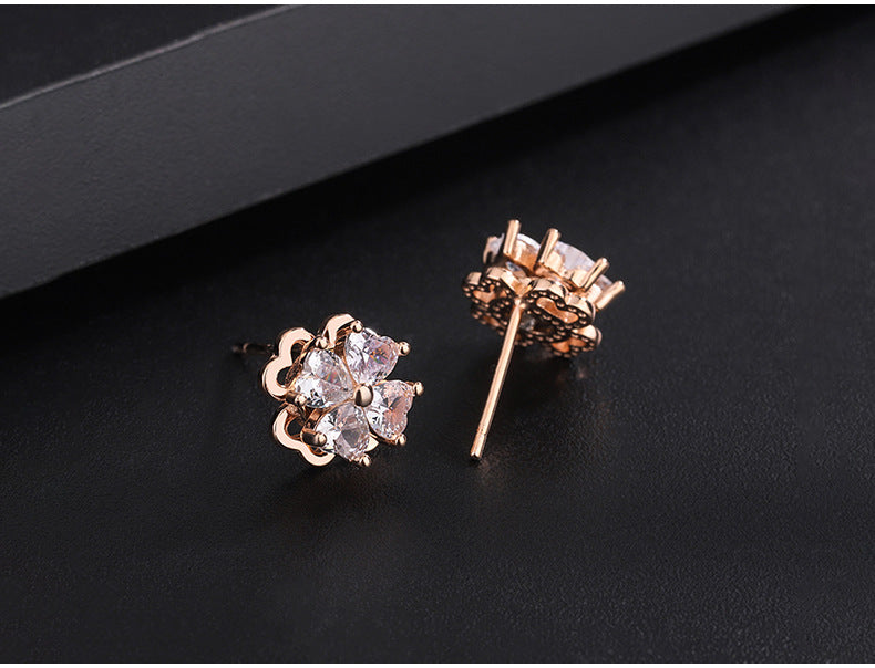 Sterling silver four-leaf clover revolving zircon earrings