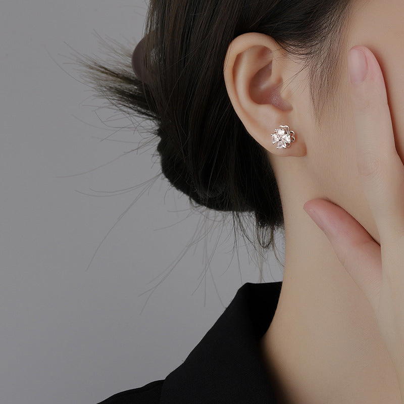 Sterling silver four-leaf clover revolving zircon earrings